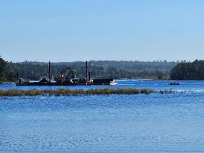 Body of water with construction equipment.