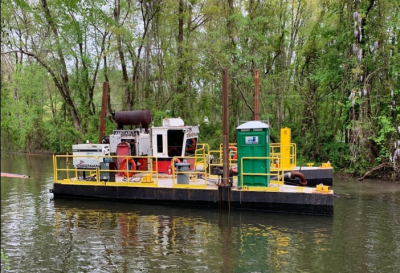 dredging equipment mounted on small boat