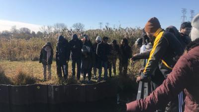 students gathered around Wolf Lake