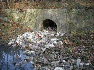 trash at a stormwater drain near a Great Lake