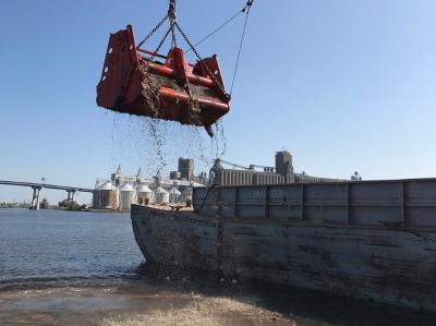 The first bucket of material removed from Howards Bay. (Photo Credit: USACE)