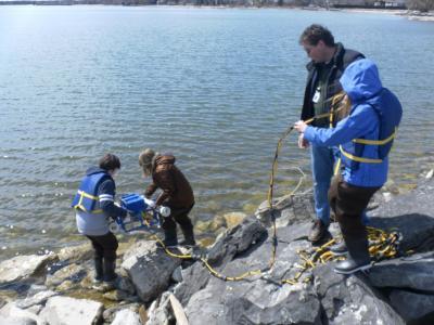 As a student, Liz Thomson (standing at right with her father) participated in the Thunder Bay Watershed Project taught by her dad, Bob Thomson. (Credit: Brandon Schroeder, Michigan Sea Grant)