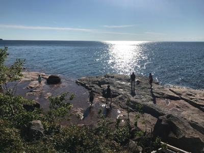 Students explore the lakeshore on a canoe trip supported by the Red Cliff Band of Lake Superior Chippewa and partner Apostle Islands National Lakeshore Park. The trip was one part of the project Nibi gaa-gikinoo’amaage, Nibi gaa-bimaaji’iwemagak (Water Will Teach, Water Will Give Life). (Credit: Alex Breslav)