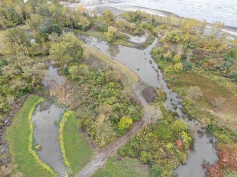 Aerial of Blasdell Creek pathway before it empties into Lake Erie and the adjacent wetland outlet facing southwest after wetland enhancements. 