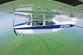 Photo of a group of scientists aboard a small aircraft obtaining hyperspectral imagery of a Lake Erie algal bloom.