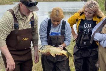 Biologist holding a fish