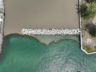 An aerial image shows turbidity curtains placed adjacent to the breakwater at the end of Buffalo Outer Harbor Slip #3. (Credit: USACE Buffalo District)